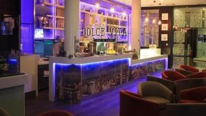 a bar in a restaurant with purple lights at Appartement plage et piscine Andalucia Beach Hôtel in Bizerte