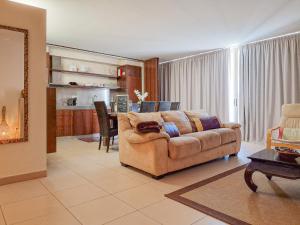 a living room with a couch and a table at Apartamentos Herdade dos Salgados in Albufeira