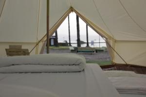 a tent with two pillows on a bed at Mia Glamping Kinneret in HaOn