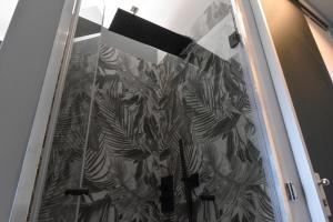 a glass door with a plant pattern on it at C-Home in Otranto +22 photos