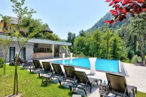 a group of chairs sitting next to a swimming pool at Vila Sunce Village Resort Konjic in Konjic