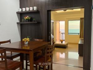 a dining room with a table and a view of the ocean at The Corus Suites Port Dickson By MAISON in Port Dickson