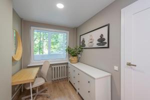 a home office with a desk and a window at Convenient apartment with balcony by Polo Apartments in Kaunas