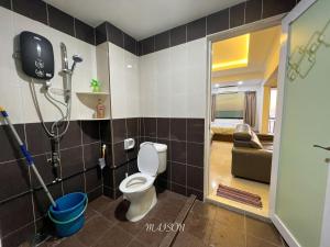 a bathroom with a toilet in a room at The Corus Suites Port Dickson By MAISON in Port Dickson +11 photos
