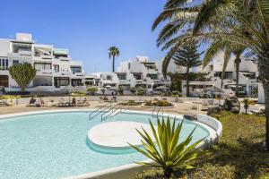 a large swimming pool in front of a resort at Holyhome mills 1113 in Costa Teguise