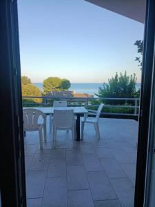 - une table et des chaises sur une terrasse avec vue sur l'océan dans l'établissement terrazza vista mare, giardino, parcheggio, wi fi, à Numana