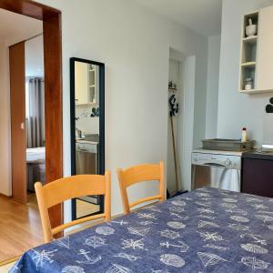 a bedroom with a table and two chairs and a mirror at Apartment Sidro in Poreč