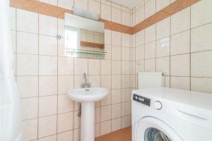 a bathroom with a washing machine and a sink at Urban Apt Next University 14 in Heraklio