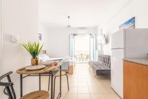 a kitchen and living room with a table and a refrigerator at Urban Apt Next University 14 in Heraklio