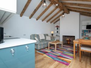 a kitchen and living room with a couch and a table at Pass the Keys Charming Garden cottage with parking in Bath