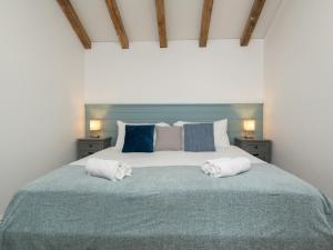 een slaapkamer met een groot bed en 2 handdoeken bij Pass the Keys Charming Garden cottage with parking in Bath