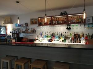 a bar with a lot of bottles on the wall at Malì Trevignano Piccolo Hotel in Trevignano Romano