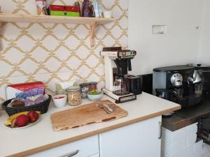 a kitchen counter with a coffee maker and a cutting board at Sparreholm Bed and Breakfast in Sparreholm
