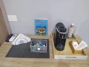 a table with a blender and other items on it at The Queen Tropea in Tropea