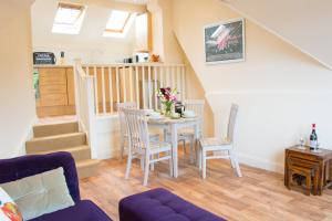 a living room with a table and chairs at York Terrace Apartments - Norwich City in Norwich