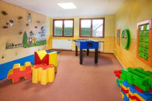 a room with a table and some toys in it at Hotel Restaurant JÄGERHAUS in Meckenbeuren