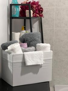 a pile of towels on a shelf in a bathroom at Gîte Le Crot de Villiers avec Bain Nordic in Dornecy +31 photos