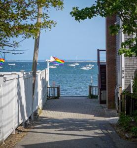 a kite flying over the ocean next to a building at Martin House 157 in Provincetown