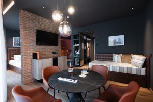a room with a table and chairs and a bedroom at Savoy Beach Hotel & Thermal Spa in Bibione
