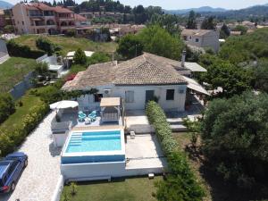 an aerial view of a house with a swimming pool at Summer House in Corfu Town in Mantoúkion