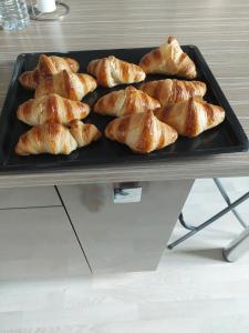 a tray filled with croissants on top of a table at L'hacienda de Maria montchanin in Montchanin