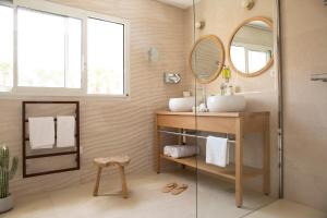 uma casa de banho com um lavatório e um espelho em Les Bulles de Mer - Hotel Spa sur la Lagune em Saint-Cyprien