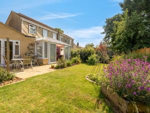 a home with a garden with purple flowers at Pass the Keys Spacious family home with parking in Bath