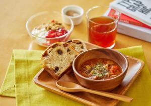 a plate of food with a bowl of soup and bread at Hotel Graphy Nezu in Tokyo