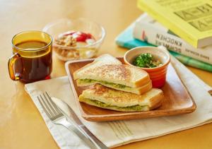 a sandwich on a cutting board on a table at Hotel Graphy Nezu in Tokyo