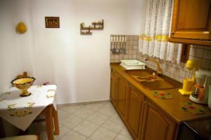 a kitchen with a sink and a counter top at Avlonitis Rooms in Parga