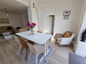 a living room with a white table and chairs at Rossendale by Cliftonvalley Apartments in Bristol