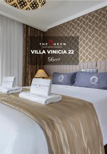 a hotel room with a bed with two pillows on it at The Queen Luxury Apartments - Villa Vinicia in Luxembourg