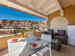 a dining room with a table and chairs with a view at B&B Simius Bay in Villasimius