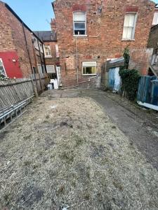 an empty alley in front of a brick building at Ground Floor 2 Bed Flat with Garden North London in London