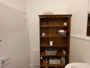 a wooden shelf in a bathroom with a sink at Ground Floor 2 Bed Flat with Garden North London in London