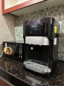 a coffee maker sitting on top of a kitchen counter at Rasa Sayang Homestay Shah Alam in Shah Alam