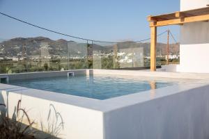 a swimming pool on the side of a house at Iphimedeia Luxury Hotel & Suites in Naxos Chora