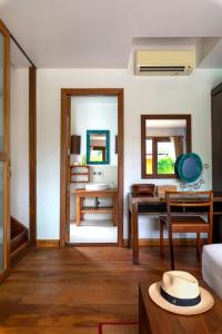 a living room with a table and a desk at Tinkerbell Resort @ Koh Kood in Ko Kood