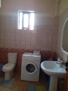 a bathroom with a washing machine and a sink at Orikum beach in Orikum