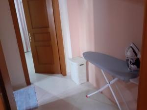 a room with a table and a door and a trash can at Orikum beach in Orikum