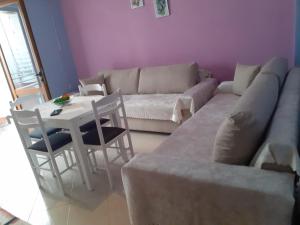 a living room with a couch and a table at Orikum beach in Orikum