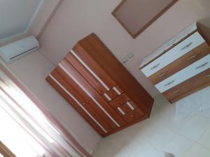 an empty room with wooden cabinets and a window at Orikum beach in Orikum