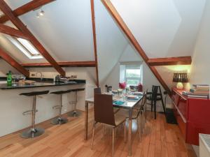a kitchen and dining room with a table and chairs at Apartment 2, Gorwel Glas in Pwllheli