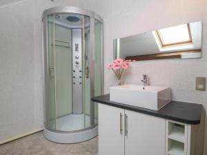 a bathroom with a sink and a mirror at Apartment 2, Gorwel Glas in Pwllheli +25 photos