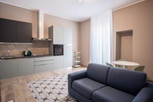 a living room with a couch and a kitchen at Palazzo Zippitelli Apartments in Bari
