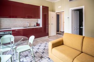 a kitchen and a living room with a couch and a table at Palazzo Zippitelli Apartments in Bari