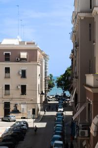 a city street with cars parked in a parking lot at Palazzo Zippitelli Apartments in Bari