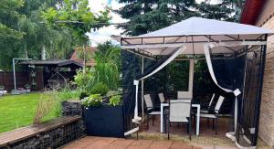 a gazebo with a table and chairs under it at Penzion Sankt Johann in Liptovský Ján +28 photos