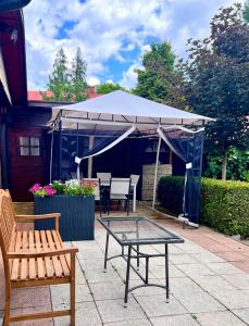 a patio with a tent and a table and chairs at Penzion Sankt Johann in Liptovský Ján