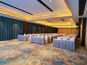 a conference room with rows of tables and chairs at Till Bright Hotel, Loudi Shuangfeng in Shuangfeng